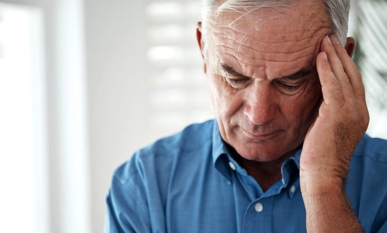 Man holding head during migraine