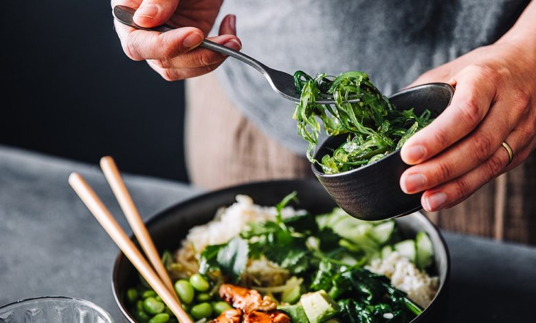 person making healthy green salad