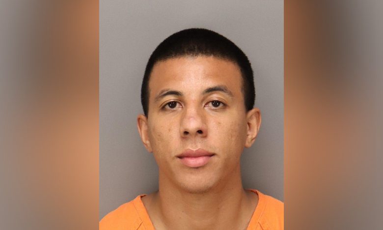 Mugshot of Taj Malik Taylor in orange jumpsuit.