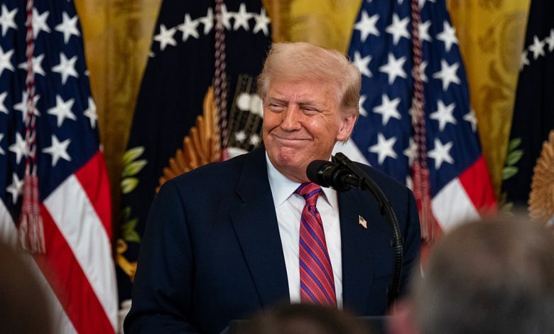 Trump grins during a signing ceremony for the GENIUS Act