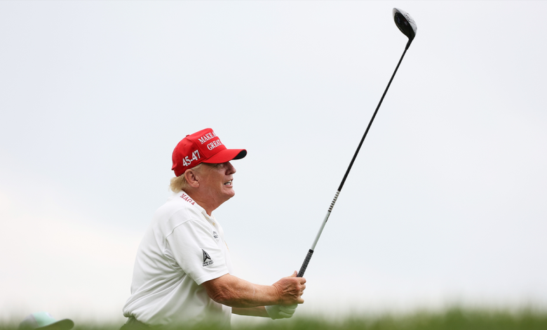 Donald Trump in white shirt and red hat swings a golf club