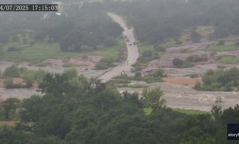 floodwaters begin overtaking small road